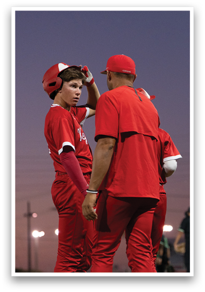 Three men in red uniforms are standing on a field, talking to each other. AI generated content