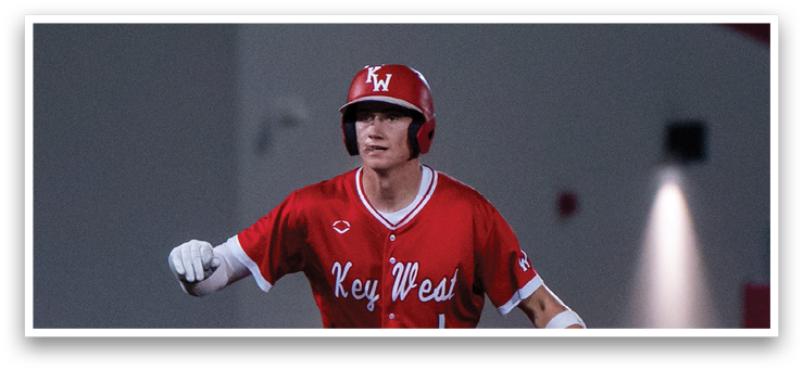 A baseball player in a red uniform is standing on the field, holding a bat and getting ready to hit the ball. AI generated content
