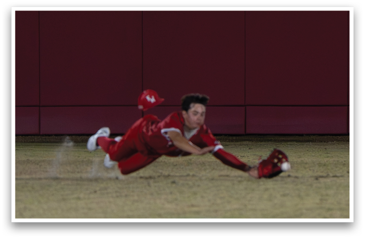 A baseball player slides into a base, wearing a red uniform. AI generated content