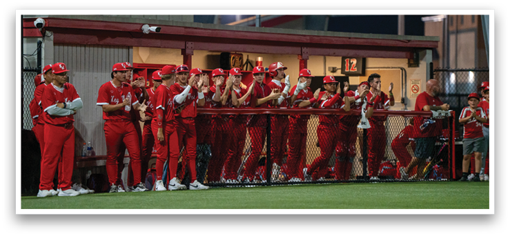 A group of baseball players wearing red uniforms are standing on a field. AI generated content