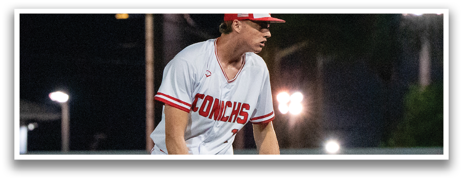 A baseball player in a red and white uniform stands on the pitcher's mound, holding a baseball glove. AI generated content