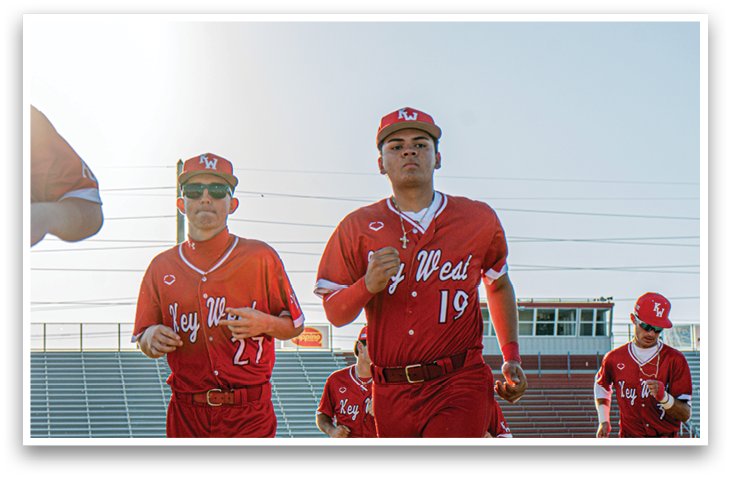 A group of men wearing red uniforms are walking on a field. AI generated content
