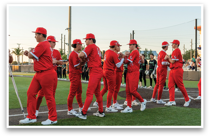 A group of baseball players wearing red uniforms are standing on a field. AI generated content