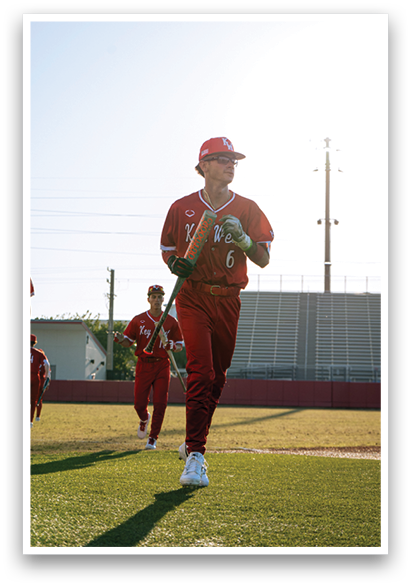 A baseball player in a red uniform walks across a field. AI generated content