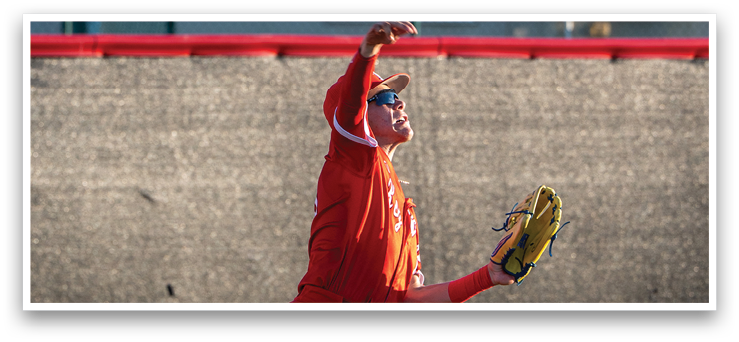 A baseball player in a red uniform catches a ball with his glove. AI generated content
