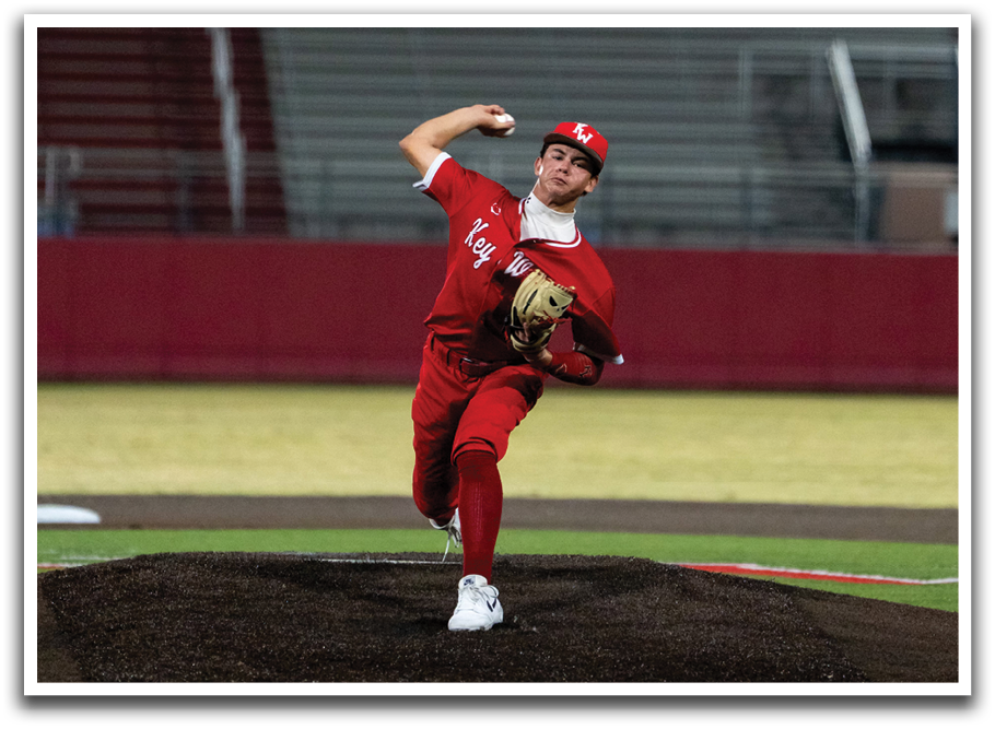 A baseball player in a red uniform is pitching a ball on a field. AI generated content