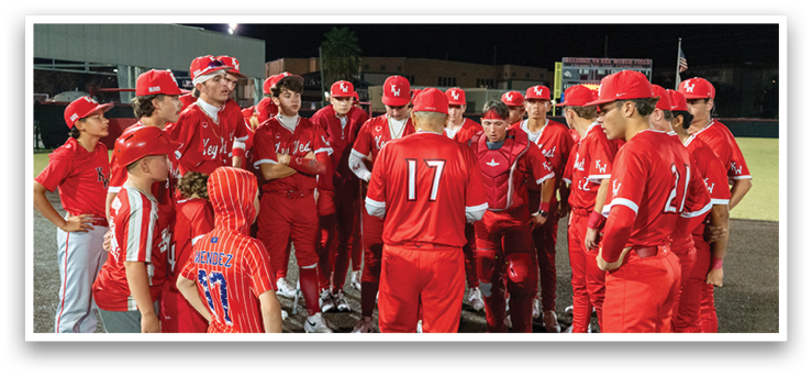 A group of baseball players wearing red uniforms are gathered on the field. AI generated content