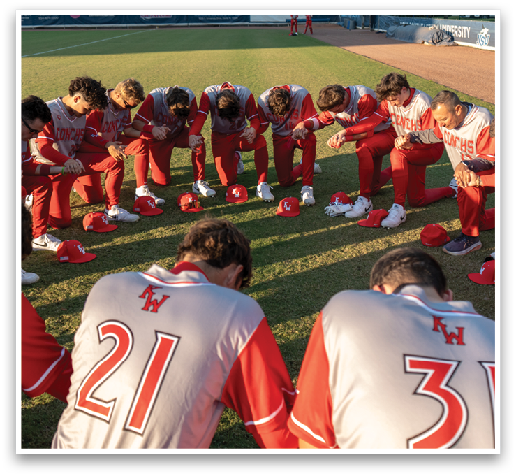 A group of baseball players kneeling on the field, wearing red and white uniforms. AI generated content