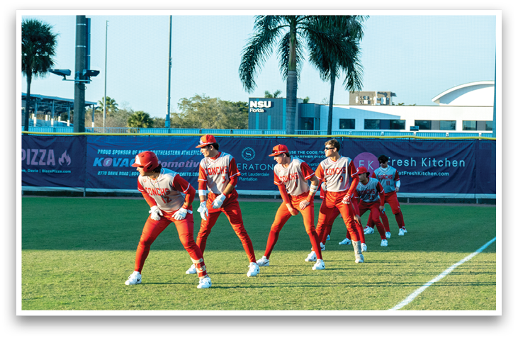 A group of baseball players wearing red uniforms are standing on a field. AI generated content