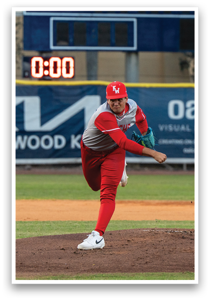 A baseball player in a red uniform is pitching a ball on a field. AI generated content