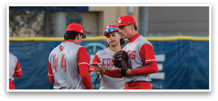 Two baseball players wearing red and grey uniforms are standing on a field. AI generated content