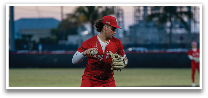 A female baseball player in a red uniform is holding a baseball glove, preparing to catch the ball. AI generated content