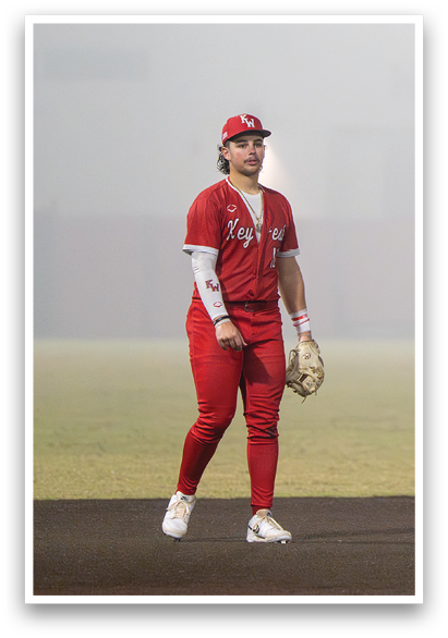 A woman in a red baseball uniform is standing on a field. AI generated content