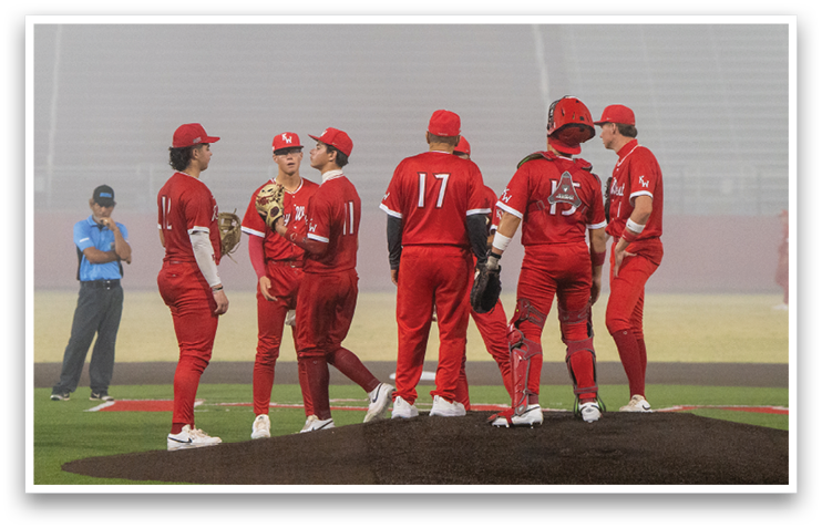 A group of baseball players wearing red uniforms are standing on a field. AI generated content