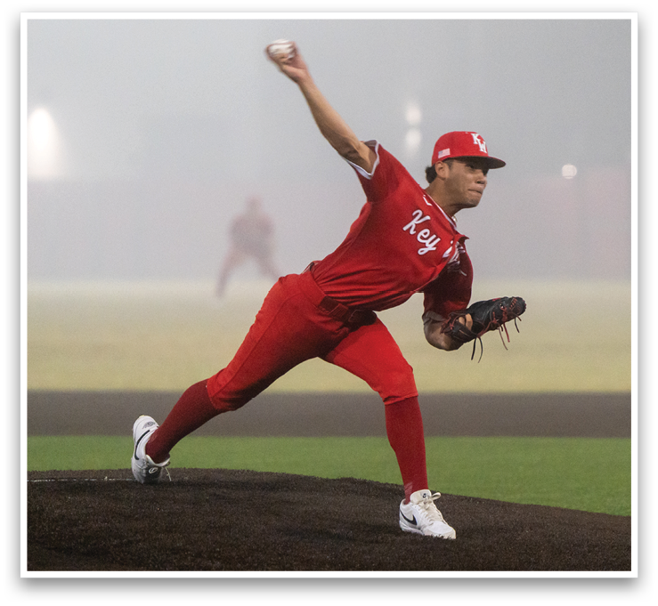 A baseball player in a red uniform is pitching a ball. AI generated content