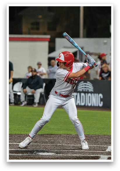 A baseball player in a red helmet and white uniform is swinging a bat at a ball. AI generated content