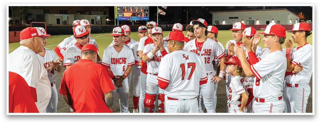 A group of baseball players wearing red and white uniforms are gathered on the field. AI generated content