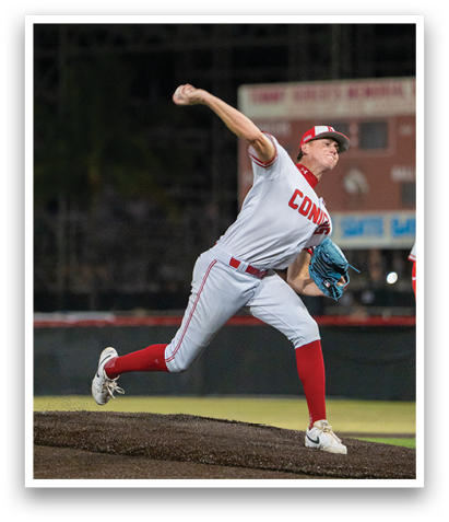 A baseball player in a white uniform is pitching a ball. AI generated content