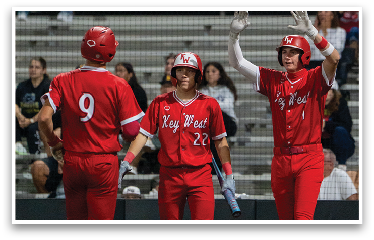 Three baseball players wearing red uniforms are standing on a field. AI generated content