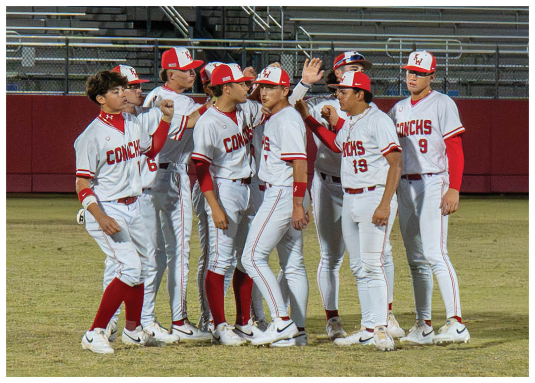 A group of baseball players wearing red hats and white uniforms are standing on a field. AI generated content