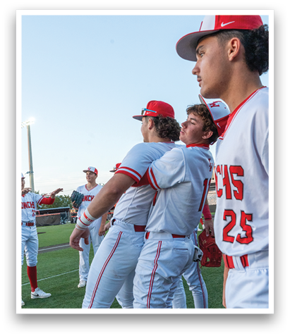 A group of baseball players wearing red and white uniforms are standing on a field. AI generated content