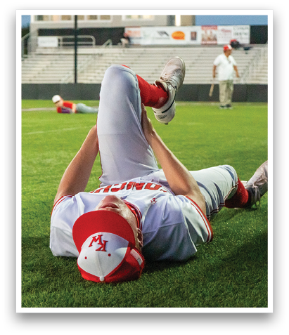 A baseball player is lying on the ground with his leg up, possibly injured. AI generated content