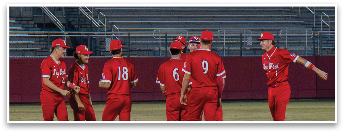 A group of baseball players wearing red uniforms are standing on a field. AI generated content