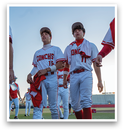 A group of baseball players wearing red and white uniforms are walking on a field. AI generated content
