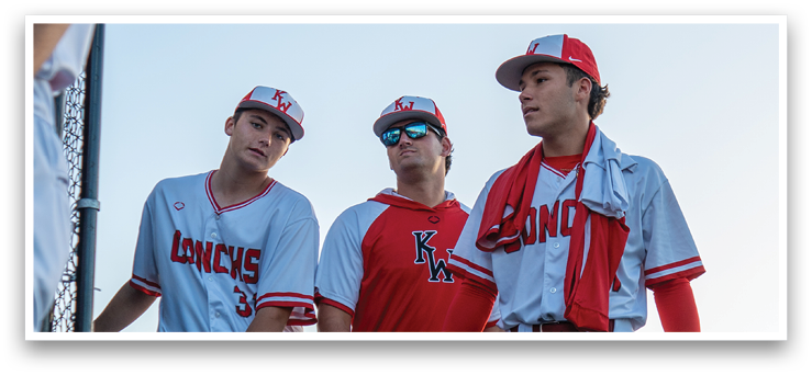 Three baseball players wearing red and white uniforms walk on the field. AI generated content