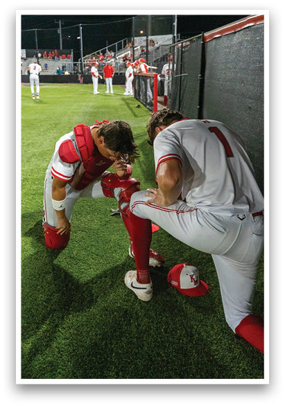 Two baseball players are kneeling on the field, one of them holding a baseball glove. AI generated content