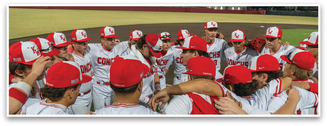 A group of baseball players huddled together on a field, wearing red and white uniforms. AI generated content