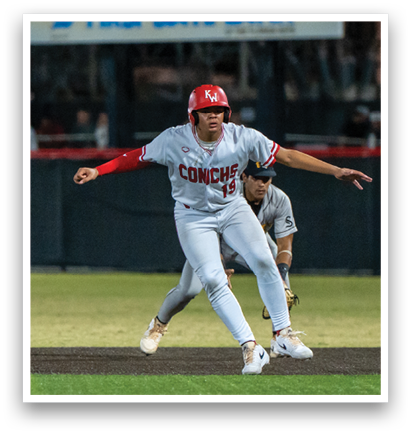 A baseball player in a red helmet and white uniform is running towards a base. AI generated content