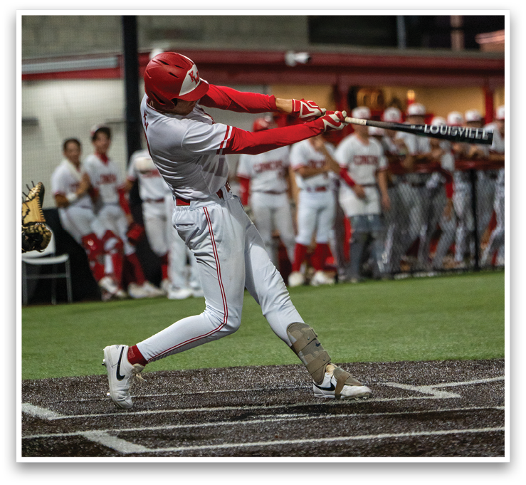 A baseball player in a white uniform is swinging a bat at a ball. AI generated content
