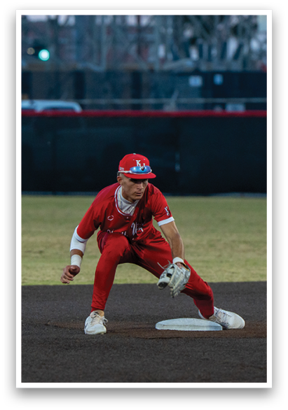 A baseball player in a red uniform is kneeling on the field, holding a baseball mitt. AI generated content