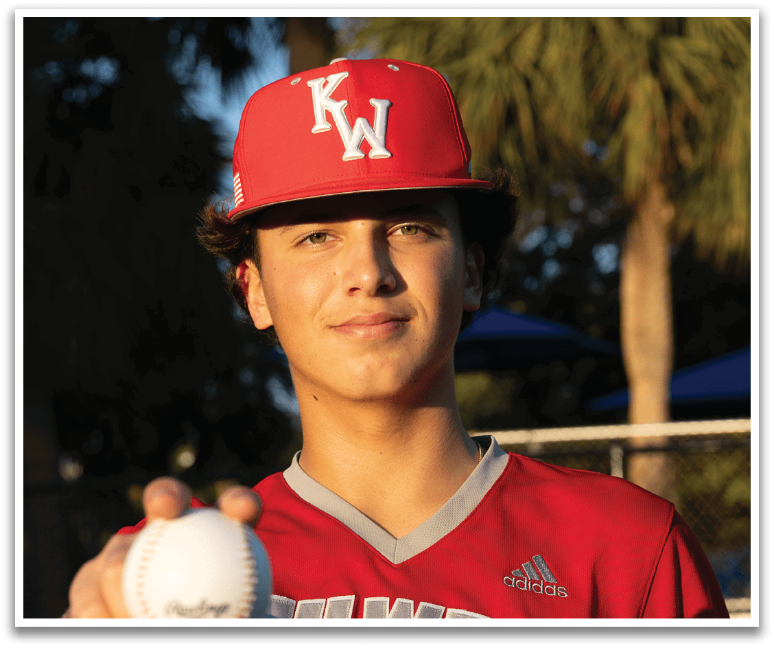 A young man wearing a red and white shirt holds a baseball in his hand. AI generated content