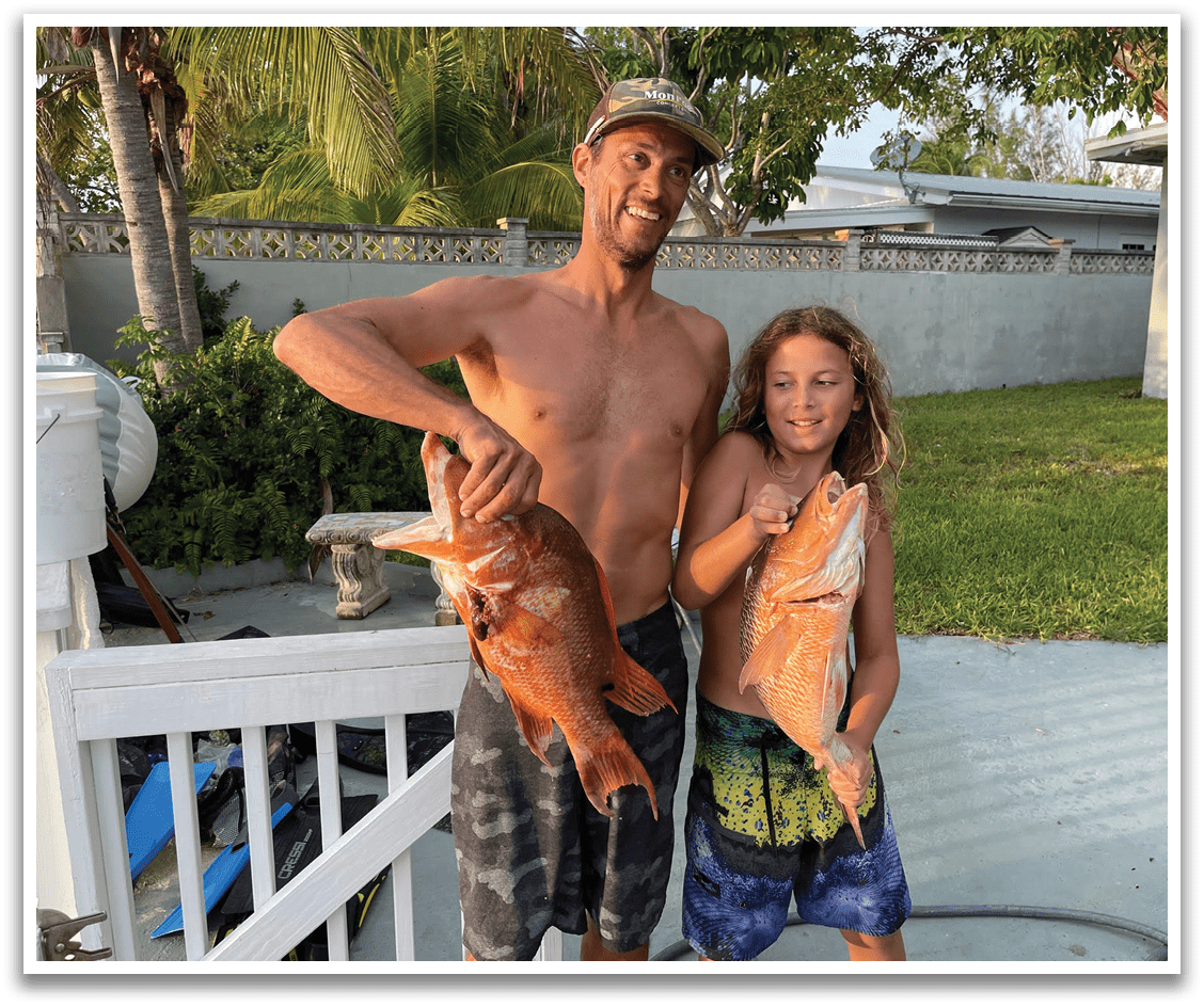 A man and a young boy are holding up fish they caught. AI generated content