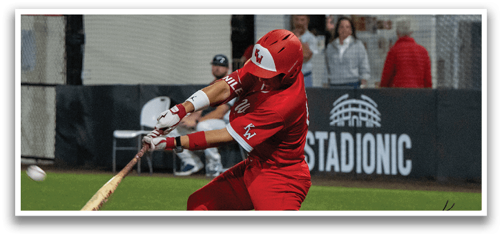 A baseball player in a red uniform swings a bat at a ball. AI generated content