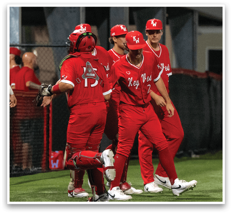 A group of baseball players wearing red uniforms are walking on the field. AI generated content
