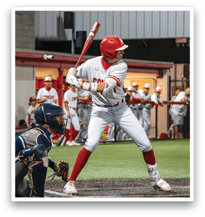 A baseball player in a red helmet and white uniform is swinging a bat on a field. AI generated content