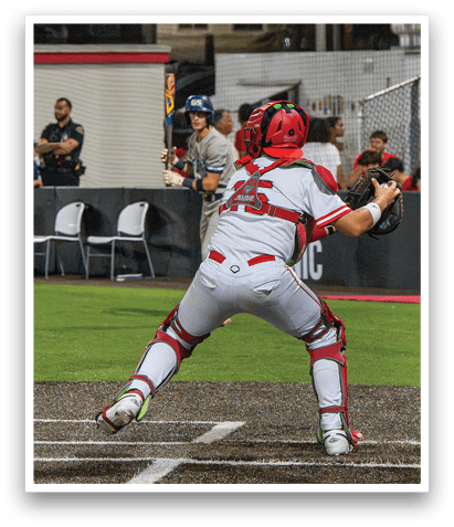 A baseball player in a white uniform is swinging a bat, attempting to hit a ball. AI generated content