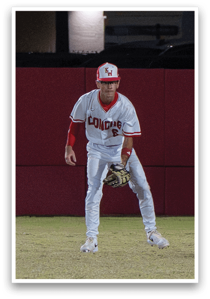 A baseball player wearing a white and red uniform stands on a field, holding a baseball glove. AI generated content