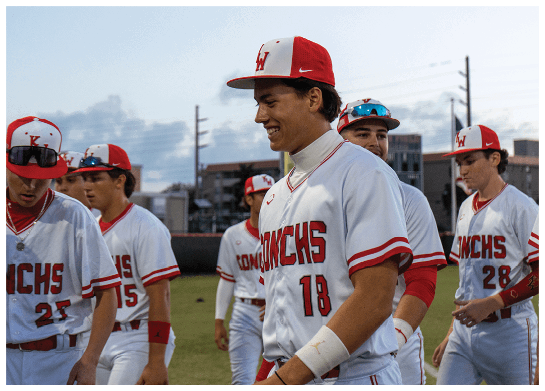 A group of baseball players wearing red and white uniforms are walking on a field. AI generated content