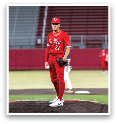 A baseball player in a red uniform stands on the pitcher's mound, getting ready to throw the ball. AI generated content