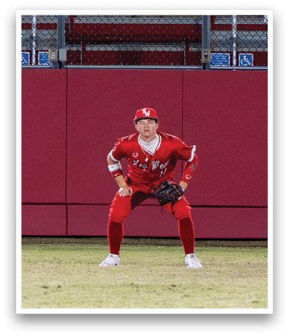 A baseball player in a red uniform is crouching on the field, wearing a baseball glove. AI generated content