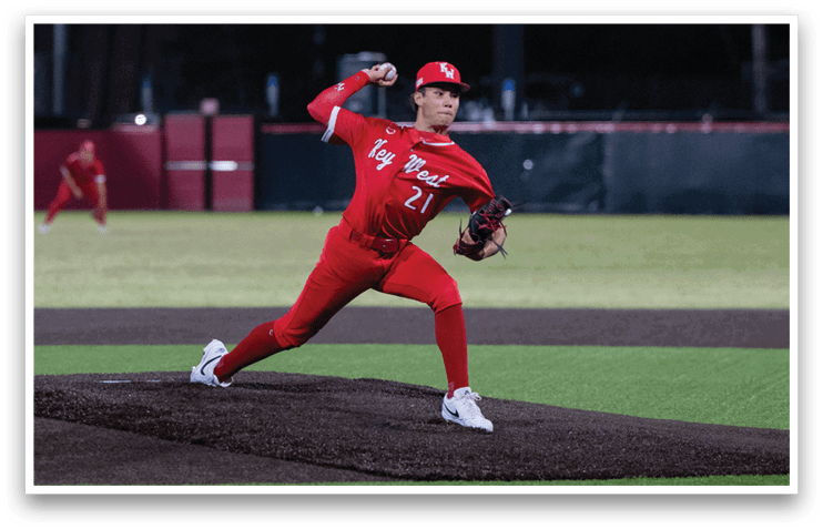 A baseball player in a red uniform is pitching a ball on a field. AI generated content