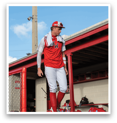 A baseball player wearing a red jersey and white pants walks out of a dugout. AI generated content