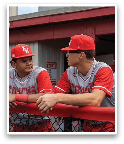 Two baseball players wearing red and white uniforms are talking to each other. AI generated content