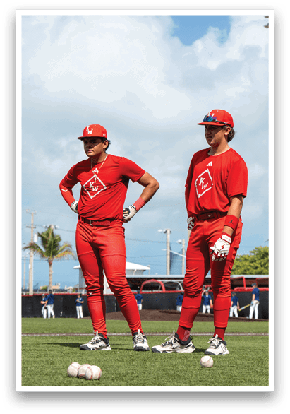 Two men wearing red shirts and red pants are standing on a field. AI generated content