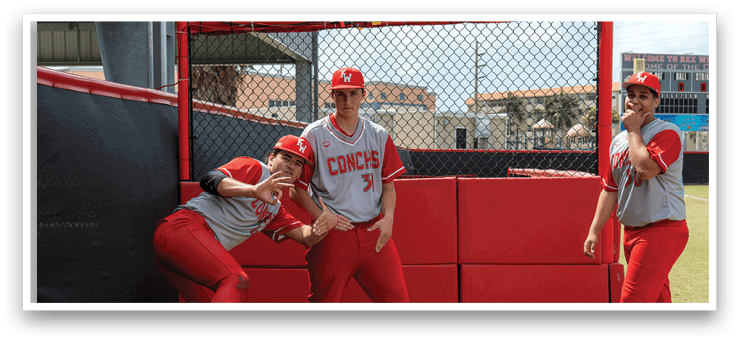 Three baseball players in red uniforms pose for a picture in front of a fence. AI generated content