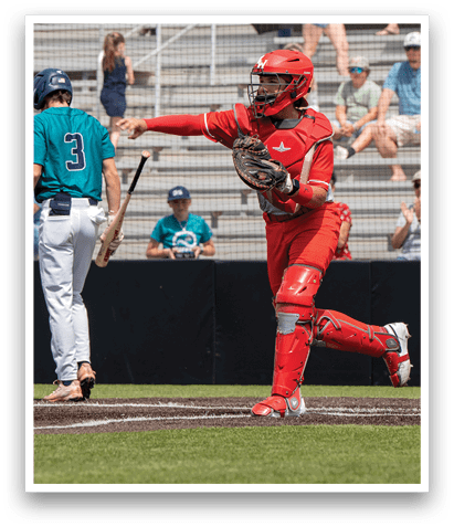 A baseball player in a red uniform is running towards home plate while another player in a blue uniform is holding a bat. AI generated content